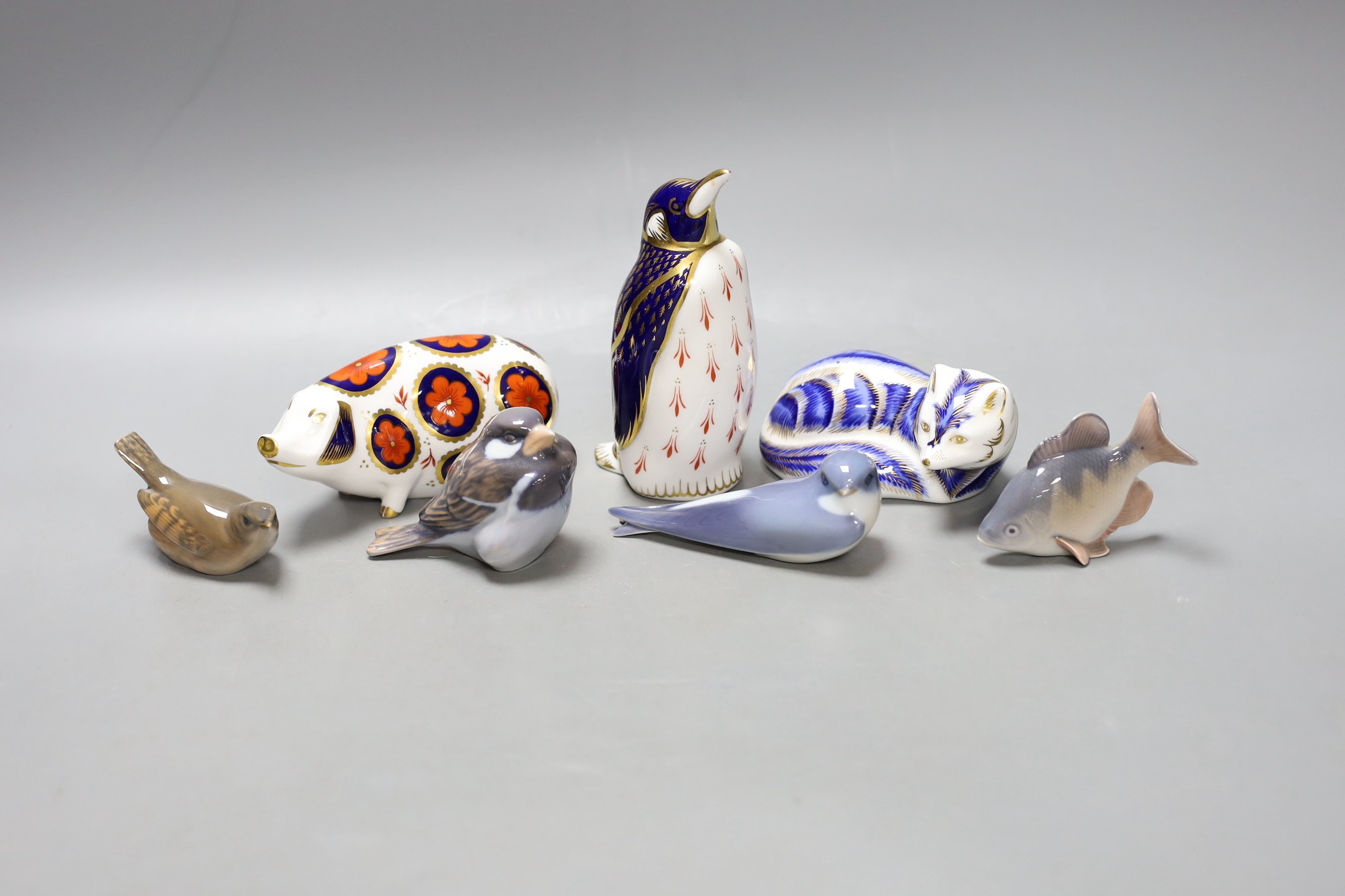 Three Royal Crown Derby paperweights, tallest 13.5cm and four Royal Copenhagen figures